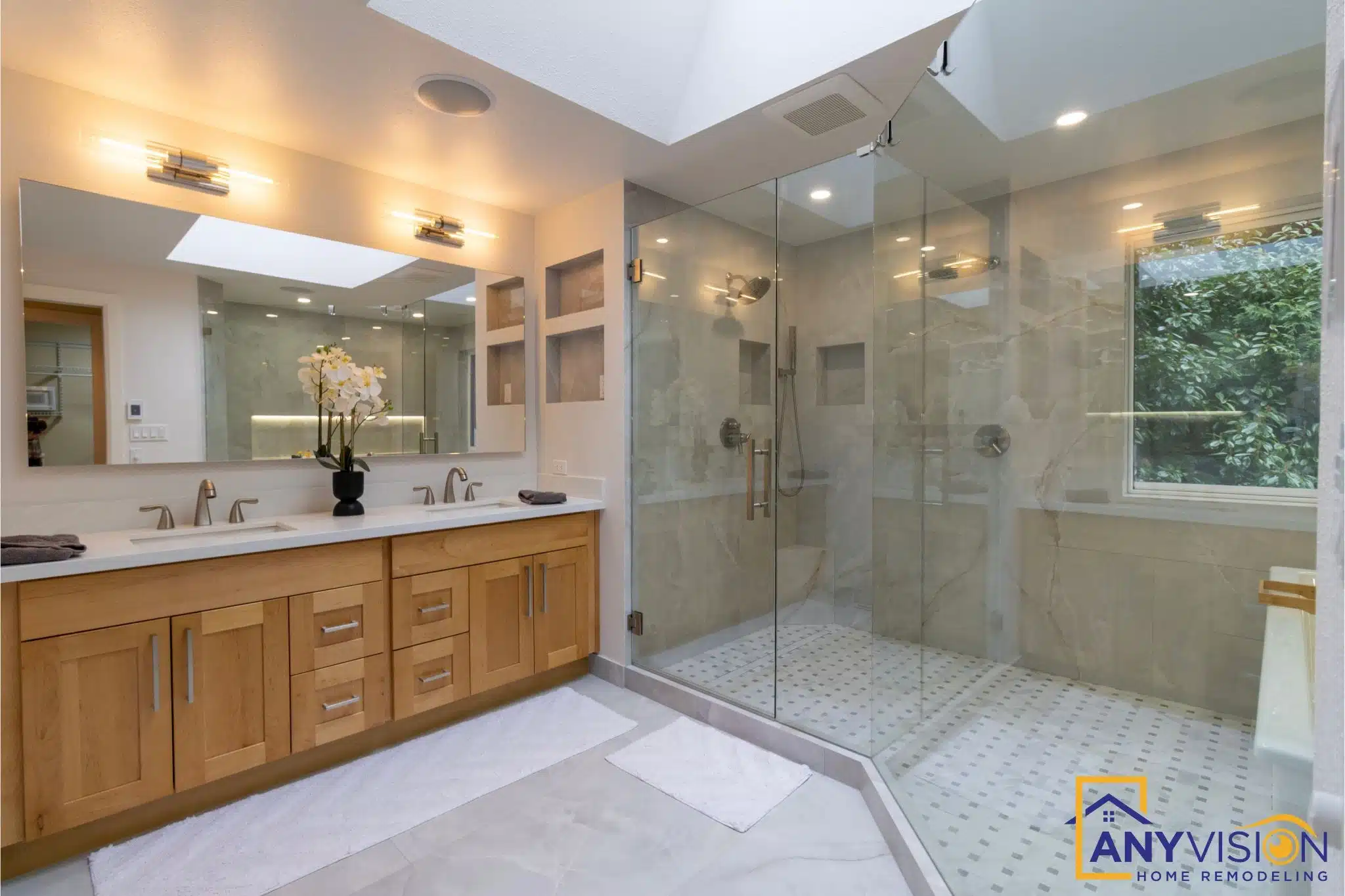 Wood vanity with a stone countertop and framed mirror beside the shower