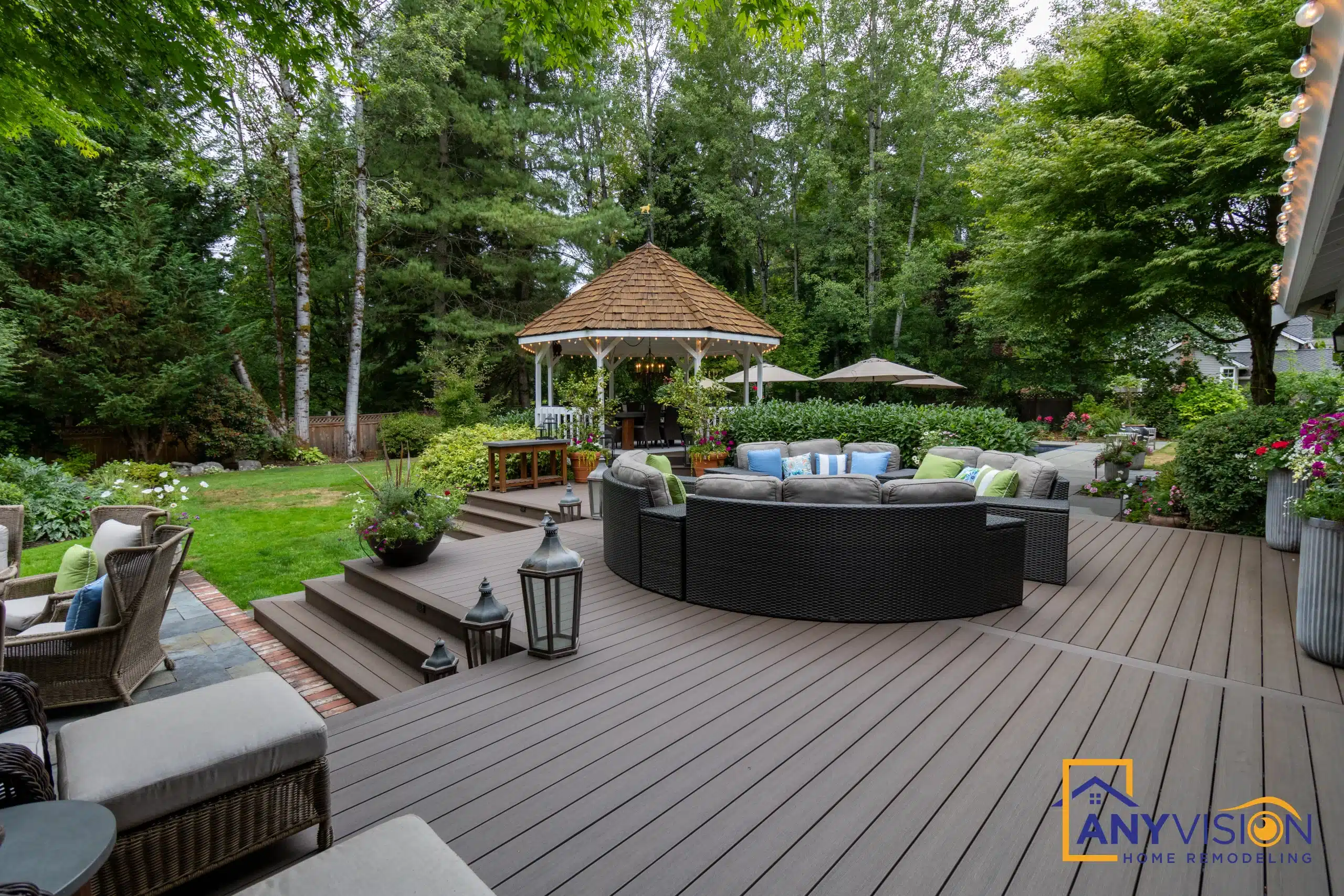Multi-level composite deck with a shingled gazebo and sectional seating in Woodinville, WA