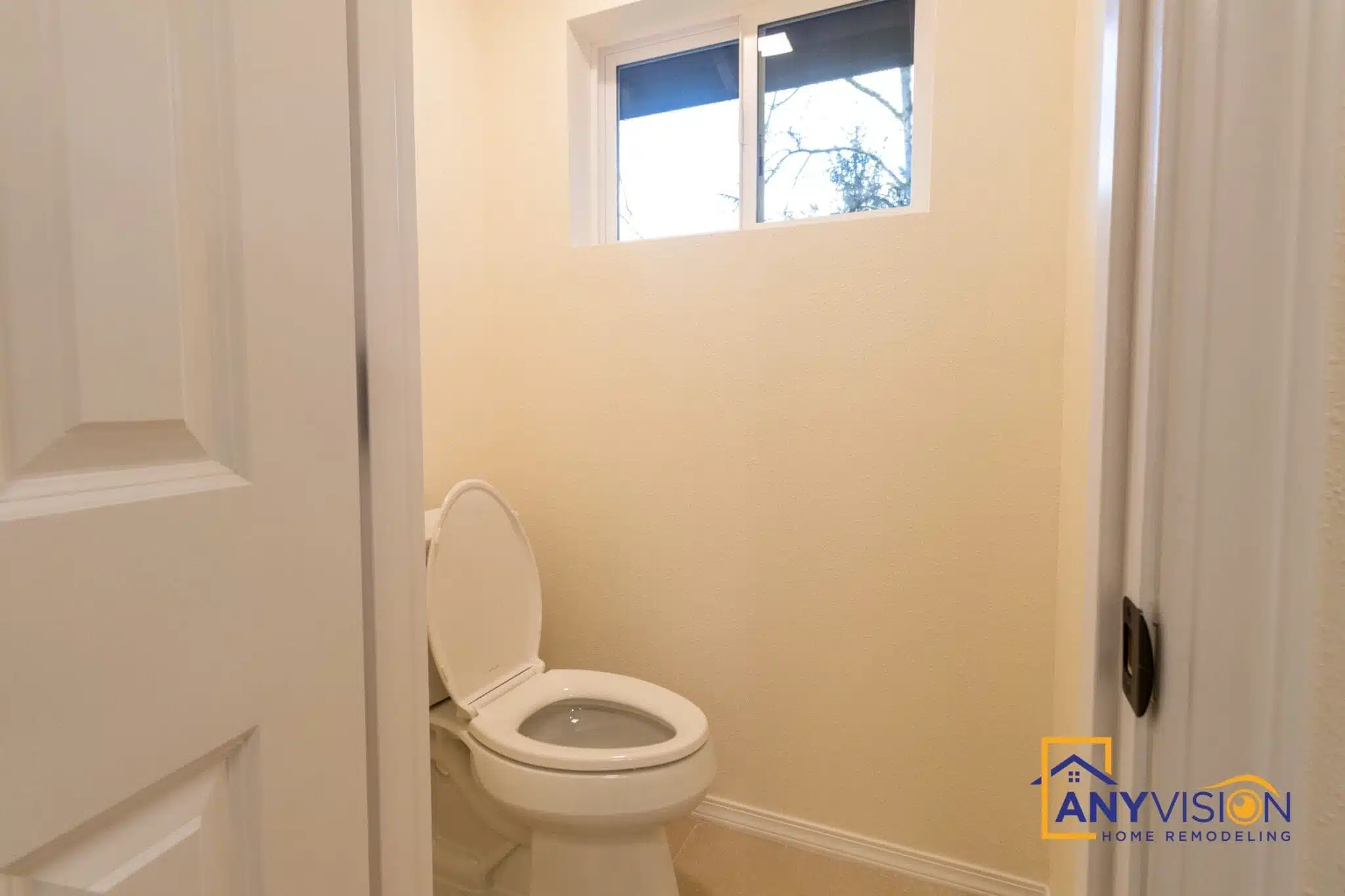WC area with a window and tiled surround